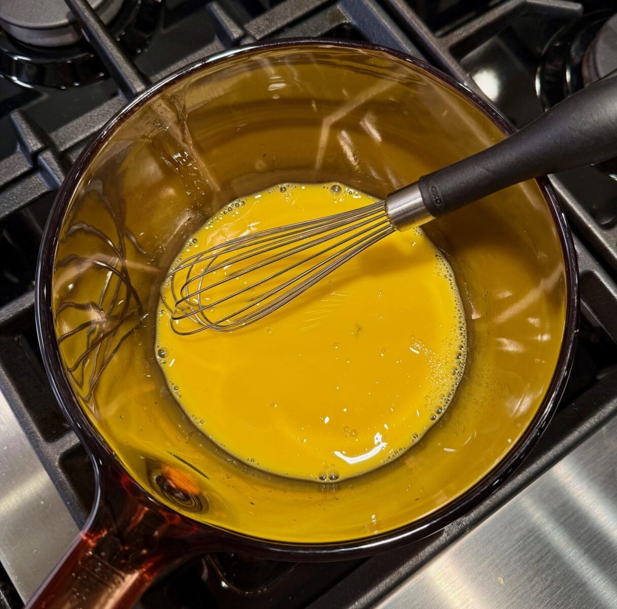 whisking eggs, lemon and water