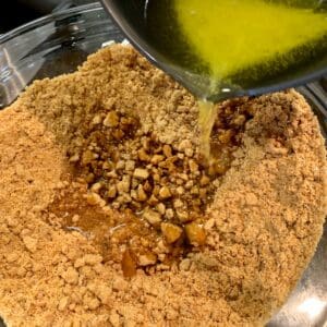 Mixing butter and cookie crumbs
