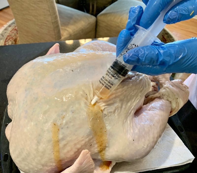 injecting the thanksgiving roast turkey with marinade