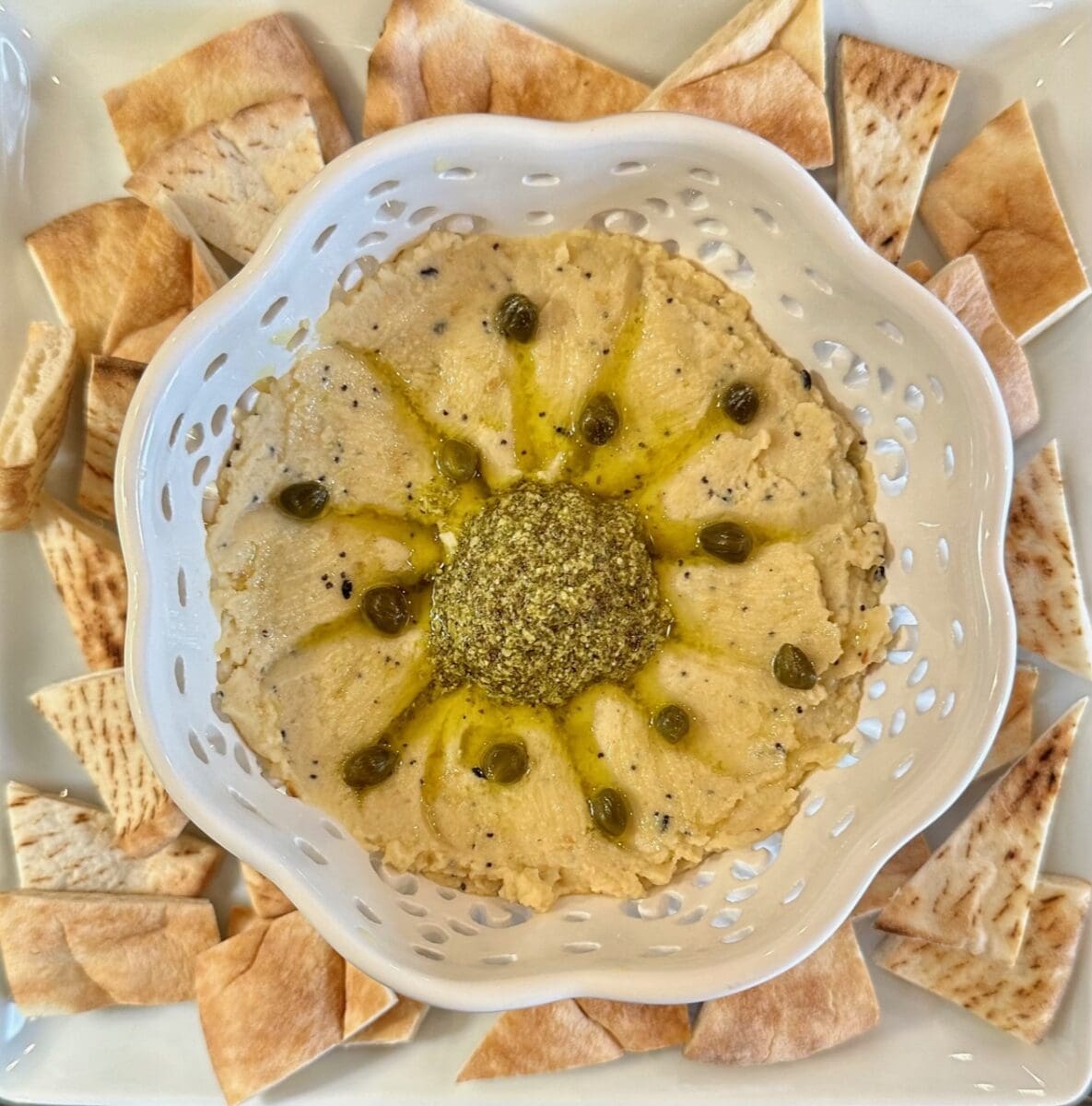 everything bagel hummus with pesto and capers