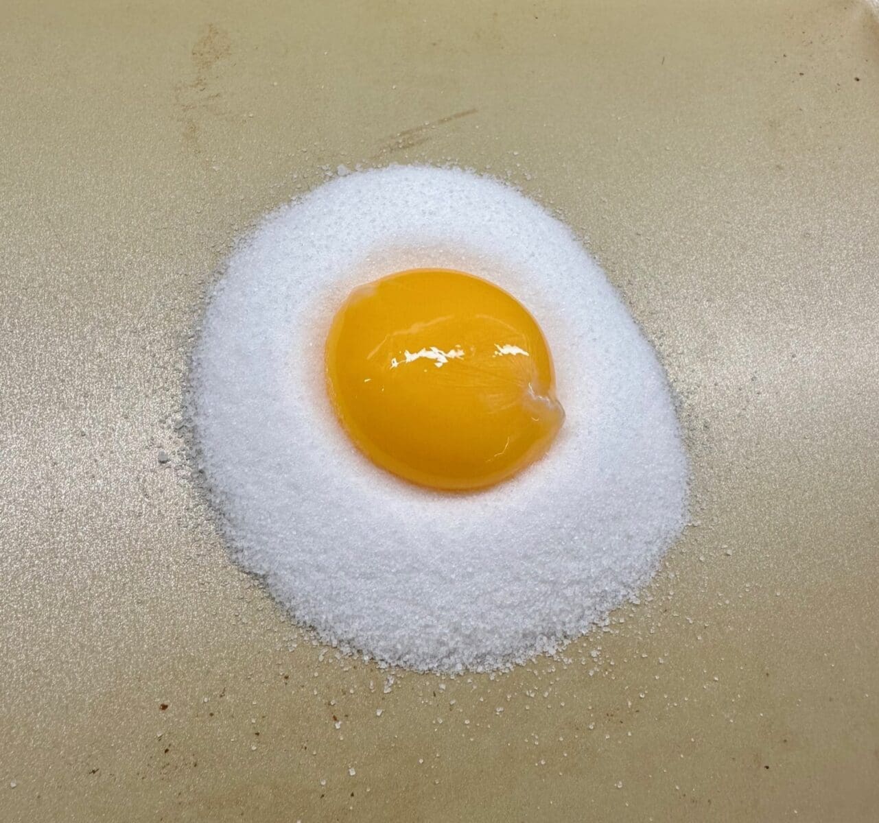 placing the egg yolk on the salt