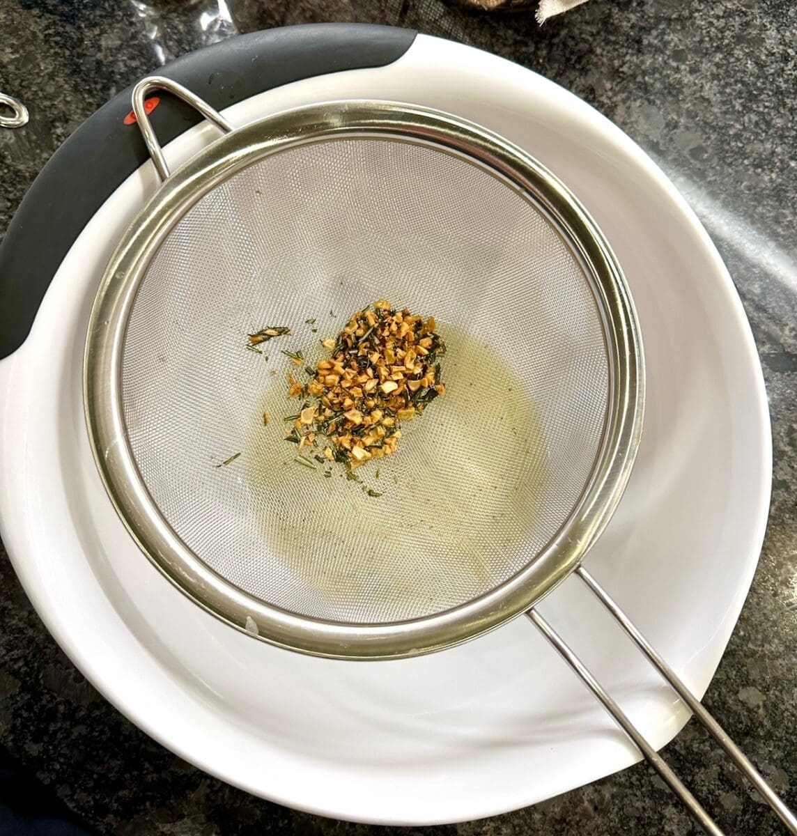 straining and separating the fat, garlic and rosemary